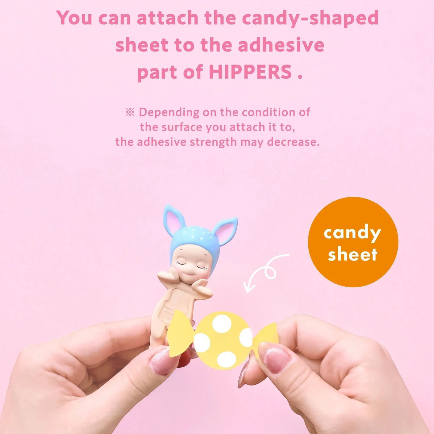 Candy-shaped adhesive sheet and small character figure, held by hands