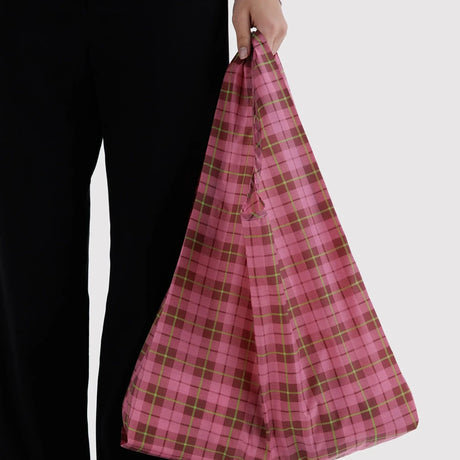 Standard Baggu reusable tote bag, pink plaid tartan, held by top handle