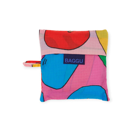 The "Baggu Standard Reusable Bag - Apples & Bananas" is a vibrant fabric pouch featuring colorful patterns and a small handle, with the "BAGGU" label prominently displayed on the front, embodying eco-chic style through its sustainable design.