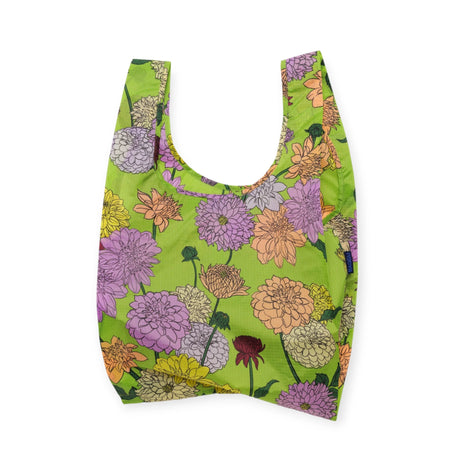 The Baggu Standard Reusable Bag - Dahlia, by Baggu, showcases vibrant floral designs on a green backdrop, making it an excellent eco-friendly option.