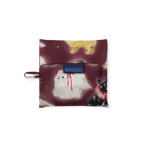 Folded Standard Baggu bag in burgundy with airbrushed fancily accessorized dogs and blue Baggu label tag