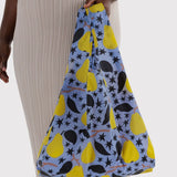 BAGGU reusable tote carried by shopper, yellow pear and star print