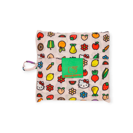 The Baggu Standard Bag - Hello Kitty Icons is a folded reusable bag with a colorful fruit and Hello Kitty pattern, adorned with a green label, highlighting its status as a Sustainable Choice.