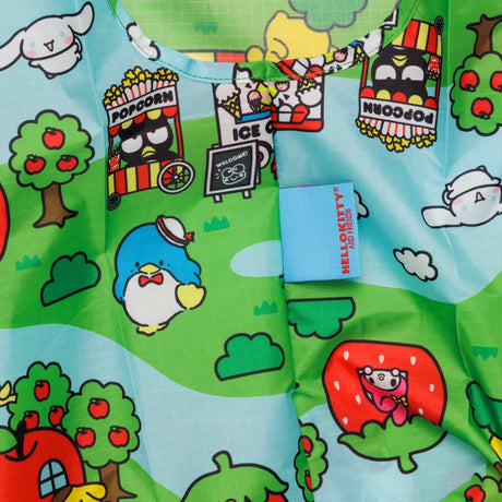 The Baggu Standard Bag - Hello Kitty Scene is made from recycled polyester and features a lively design with cartoon animals, food carts, trees, apples, and a whimsical strawberry house. It prominently displays a blue "Hellokitty World" tag, making it ideal for crafting your own distinctive Baggu bag.