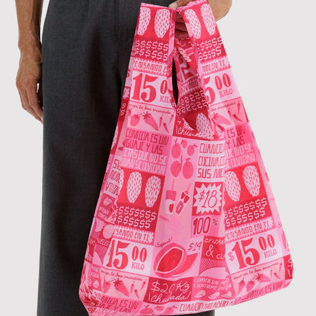 Pink printed tote bag held by a person, Mercado-style grocery shopper bag