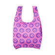 Pink reusable tote bag with navy smiley face pattern