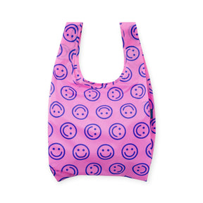 Pink reusable tote bag with navy smiley face pattern