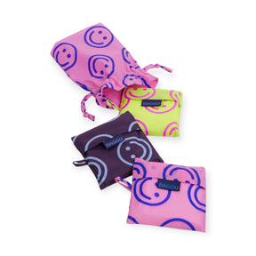 Set of 3 cloth drawstring bags with smiley prints in purple, green, and navy mix.