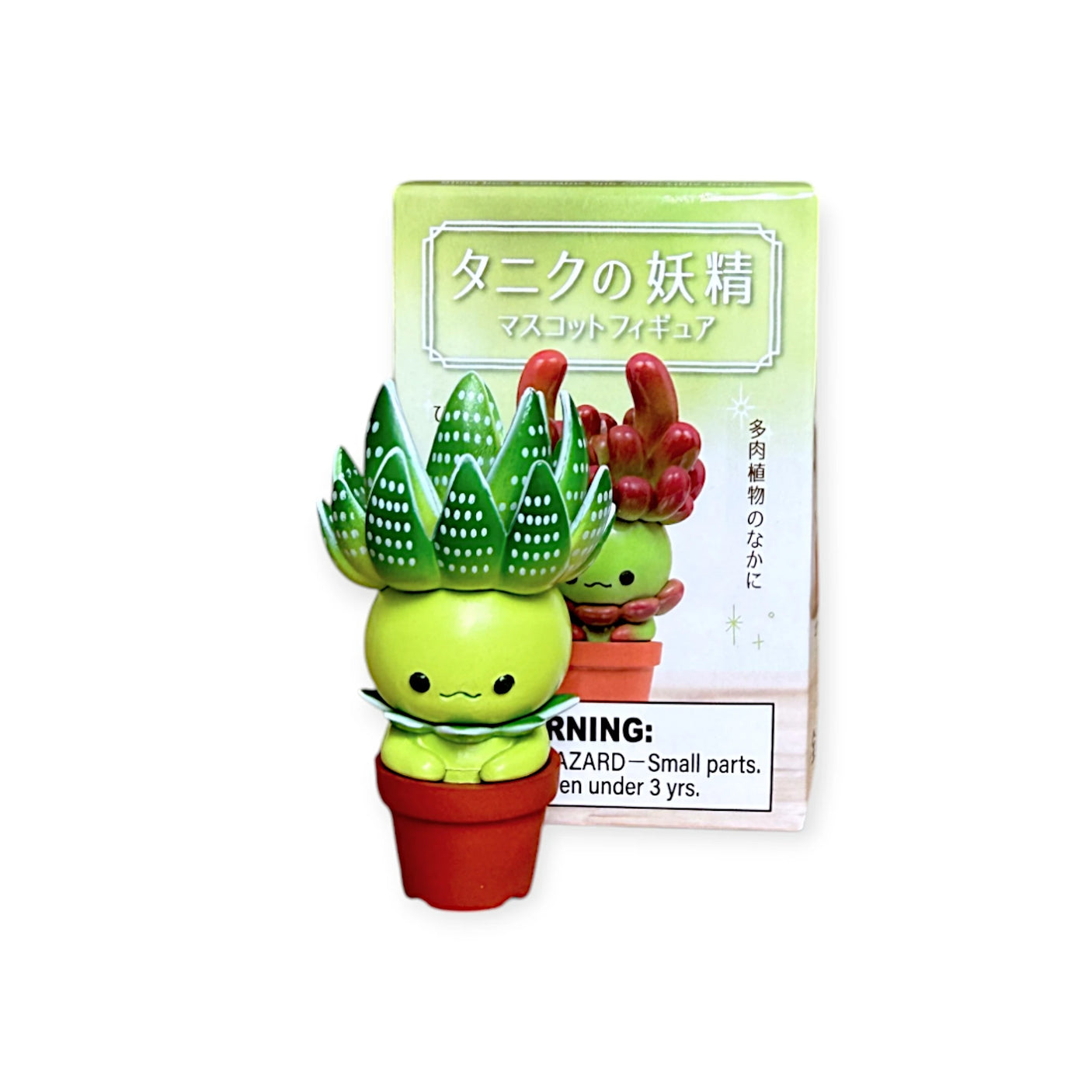 Uncover the surprise succulent character from Kitan Club's Succulent Friends Blind Box! This toy plant is small, with a green head and leaf-like spikes. The Japanese packaging cautions against small parts unsuitable for children under 3.