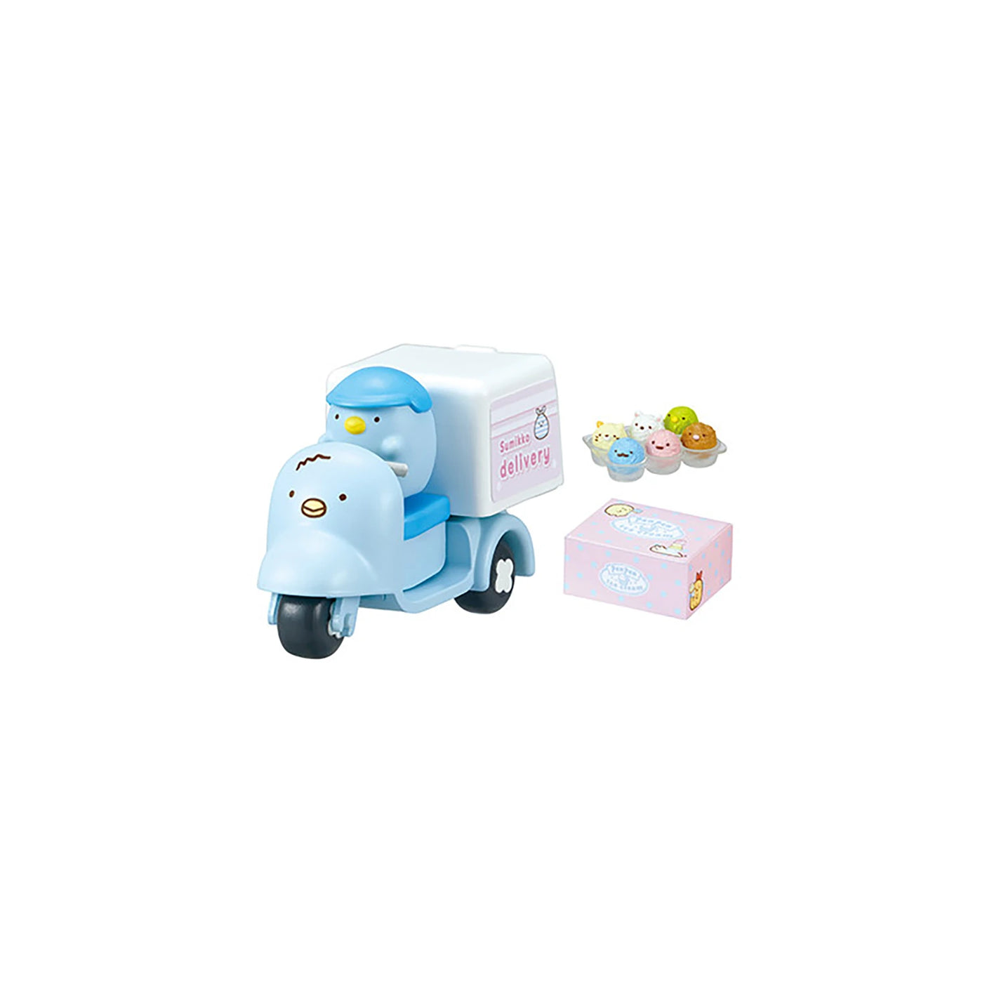 The Re-Ment Sumikko Gurashi Food Delivery Blind Box features a charming, small blue toy scooter with a penguin figurine driver. It carries a pink box along with miniature dessert figures, creating the image of an enchanting food delivery from a magical world.