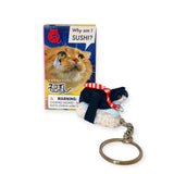 This charming Sushi Cat Keychain from Mofusand features a delightful black and white cat figure styled as sushi on a rice base. With its kawaii charm, it's part of the Sushi Cat Keychain Blind Box - Vol.1 series, packaged in an amusing box that asks, "Why am I SUSHI?