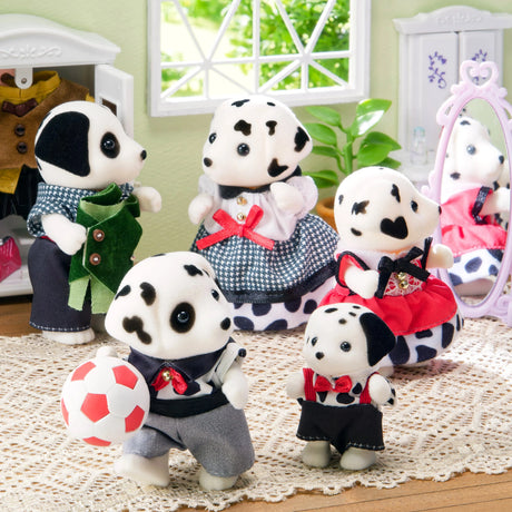 Dalmatian plush family figures posed together wearing patterned clothes and red bows