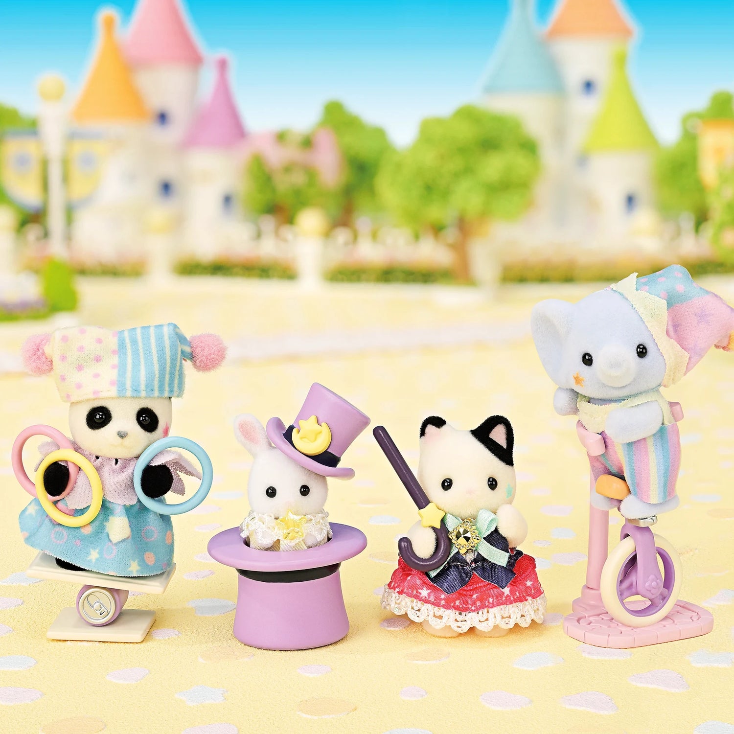Sylvanian Families - Dream Showtime Babies featuring four plush animal babies in colorful show costumes with circus props outdoors