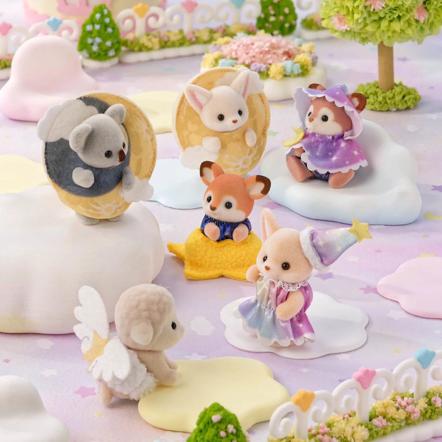 Assorted baby animal figurines with moon and star costumes in a pastel display
