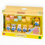 Sylvanian Families - Nursery Playmates with six baby animal figures in blue nursery outfits and pastel-colored bags in playroom setting