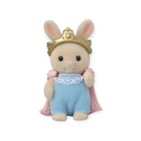 A Sylvanian Families Blind Bag - Baby Costume toy rabbit, wearing a blue outfit with lace detail, along with a gold crown and pink cape, stands upright on a white background.