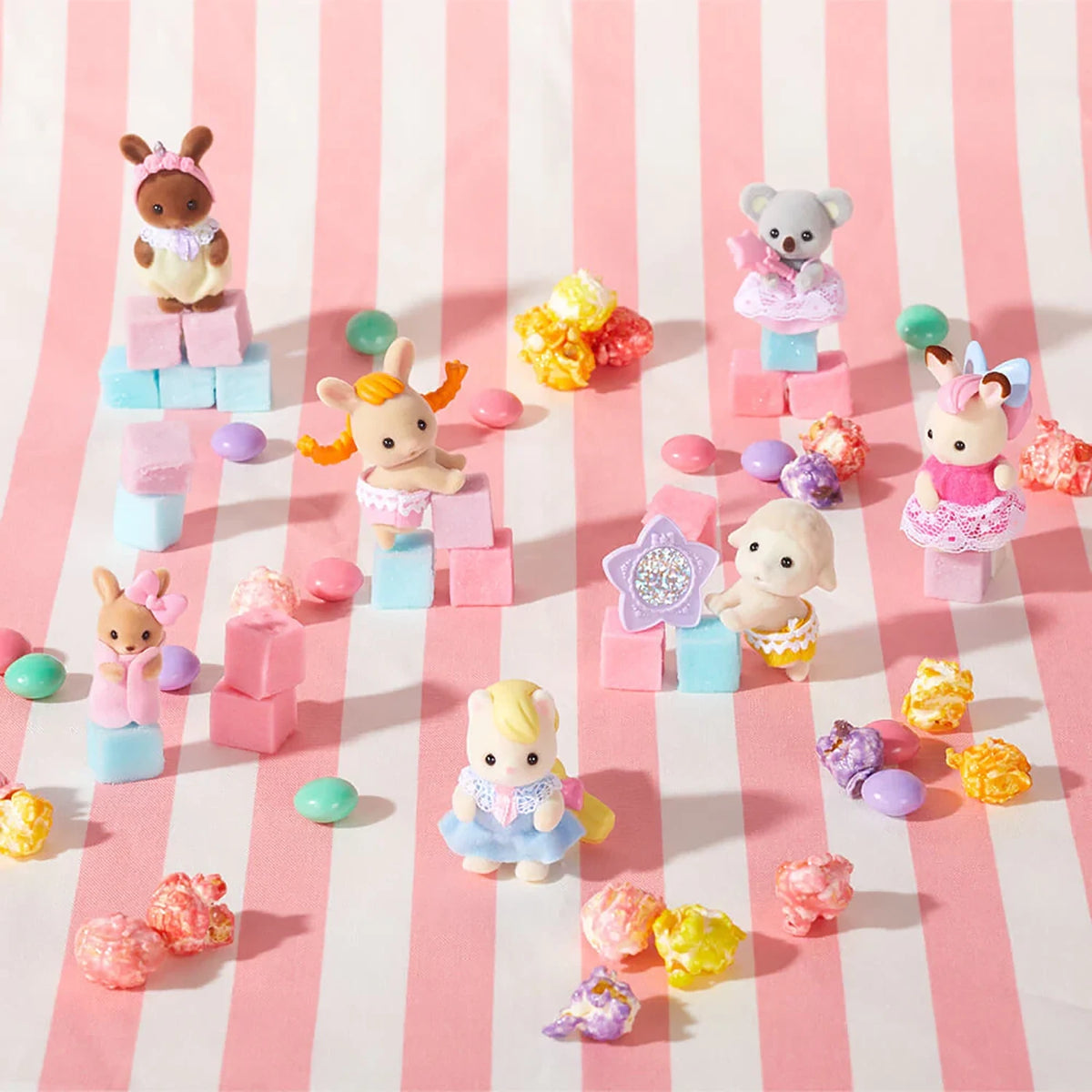 Group of small plush animal figures with colorful hair accessories and pastel outfits