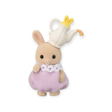 A charming figure from the Sylvanian Families Blind Bag - Baking Baby Party collection poses against a plain white background, wearing a teapot hat and a purple dress with a lace collar. This delightful piece is perfect for fans of collectible critters.