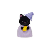 A miniature black cat toy from the Sylvanian Families Blind Bag - Magical Baby is adorned in a purple robe and hat, clutching a yellow wand, capturing the charm of the Sylvanian Families collection.