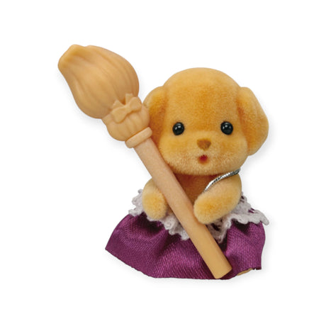 This delightful plush dog toy from the Sylvanian Families Blind Bag - Magical Baby collection features a beige wand and is dressed in an enchanting purple and white outfit, ideal for those wonderfully unexpected moments in a blind bag.