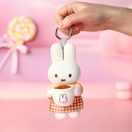 Rabbit plush keychain dangling, orange gingham dress and bunny mug detail
