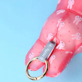 Pink plush raincoat keychain close-up with metal clasp ring and bunny pattern