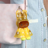 Yellow plush rabbit raincoat keychain with metal ring and small bunny print