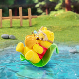 Winnie the Pooh figurine floating in a green inner tube with goggles
