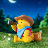Winnie the Pooh figurine in a cowboy hat holding a brown watering can
