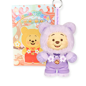 Winnie the Pooh Candy Bear plush keychain in pastel purple outfit with matching tag and colorful blind box in background