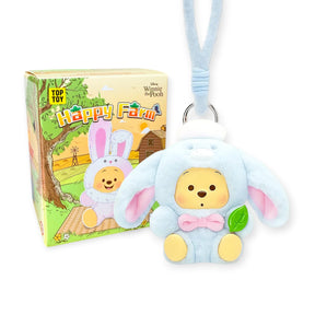 Blue bunny plush keychain with Pooh face beside Happy Farm blind box