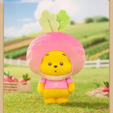 Pink root vegetable plush keychain with smiling yellow face and green leafy top