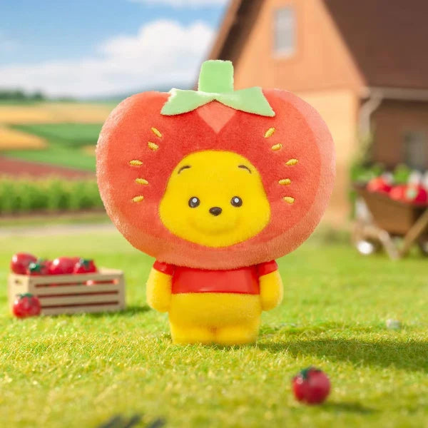 Strawberry fruit plush keychain with smiling yellow face and green leaf topper