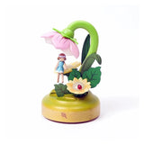 Introducing the Wooderful life - Fairy Night Light by Wooderful life: This enchanting decorative figurine serves as a wooden fairy night light, showcasing a girl beneath a large pink flower adorned with green stems and leaves. The design is beautifully completed by a smaller yellow flower accented with a red ladybug, all set on an eco-friendly rounded wooden base.