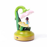 Introducing the Wooderful Life - Fairy Night Light, an eco-friendly decorative piece by Wooderful Life. This charming light includes a small figurine of a girl sheltered beneath a pink flower-shaped shade with a grassy base and features a convenient USB charging port, making it perfect for enhancing the ambiance of any room.