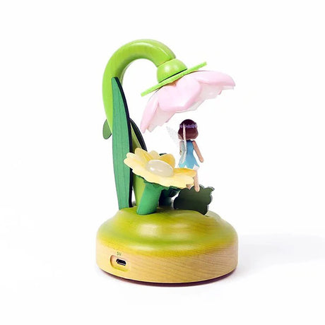 Introducing the Wooderful Life - Fairy Night Light, an eco-friendly decorative piece by Wooderful Life. This charming light includes a small figurine of a girl sheltered beneath a pink flower-shaped shade with a grassy base and features a convenient USB charging port, making it perfect for enhancing the ambiance of any room.