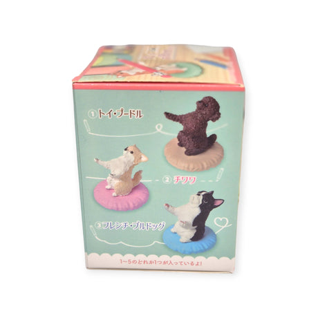 The "Pen Holding Dogs Blind Box" by Yell features illustrations of three collectible dog figurines: a Poodle, a Chihuahua, and a French Bulldog, each elegantly positioned on a round cushion with Japanese text adding an authentic touch to this delightful collection.