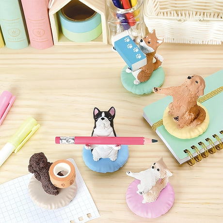 A delightful arrangement of Yell's Pen Holding Dogs Blind Box figurines adorns the desk, accompanied by an assortment of notebooks, pens, and markers.