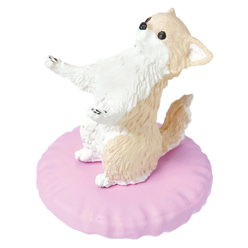 This charming fox figurine sits upright on a pink cushion, its front paws raised in playful anticipation. A delightful addition to any collection, it pairs beautifully with dog figurines or even the Pen Holding Dogs Blind Box by Yell for those who cherish whimsical collectible treasures.