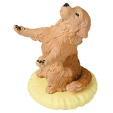 A whimsical, fluffy dog figurine rests on a yellow platform with its front paws raised. This adorable collectible is a part of Yell's Pen Holding Dogs Blind Box, offering delightful surprises featuring beloved dog breeds.