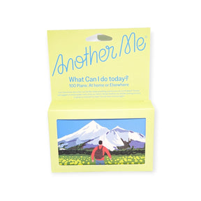 Yellow Another Me gift box with scenic mountain landscape panel and open front